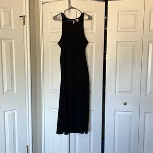 Black sleeveless dress with small slit